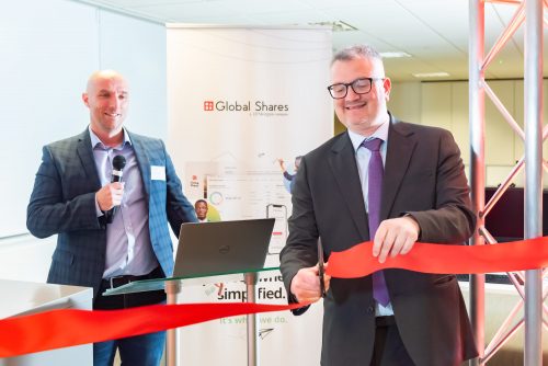 Photo of James Lewis cutting the ribbon at Global Shares